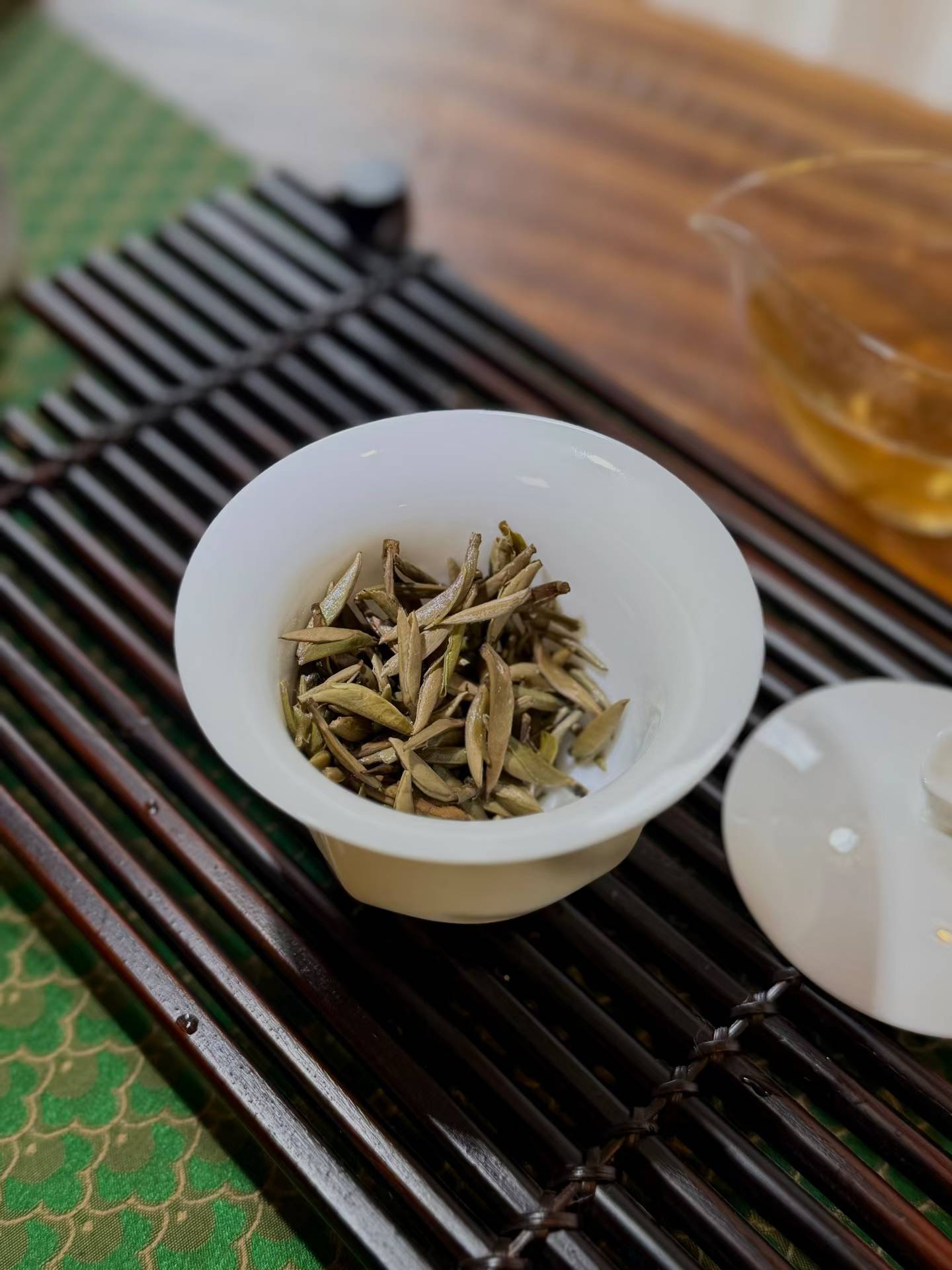 Aged Silver Needle white tea from 2020, six years matured. High-mountain single buds, honeyed aroma, warm medicinal notes, clear golden liquor. Four sealed tins — drink now or keep aging.