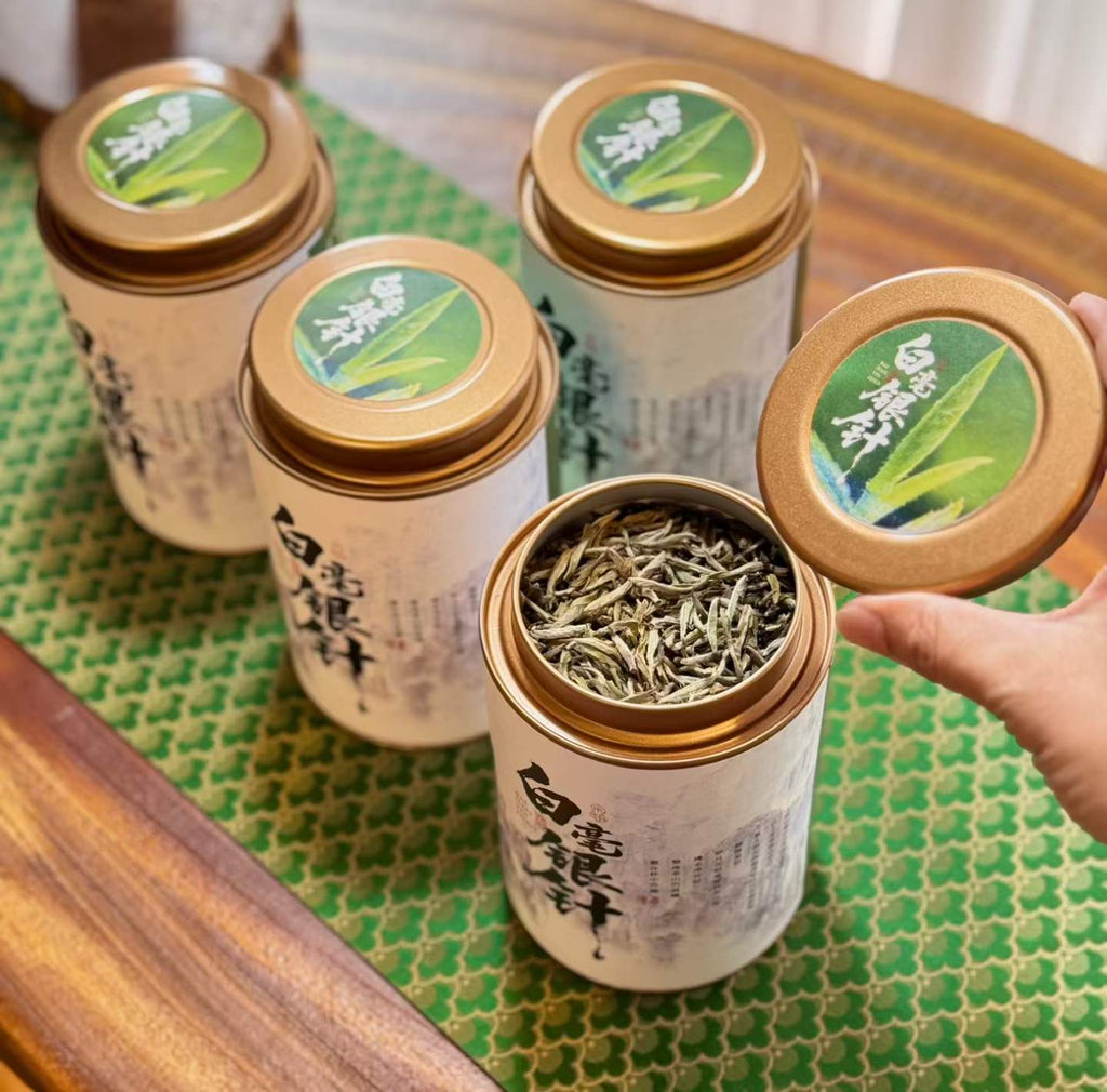 Aged Silver Needle white tea from 2020, six years matured. High-mountain single buds, honeyed aroma, warm medicinal notes, clear golden liquor. Four sealed tins — drink now or keep aging.