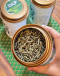 Aged Silver Needle white tea from 2020, six years matured. High-mountain single buds, honeyed aroma, warm medicinal notes, clear golden liquor. Four sealed tins — drink now or keep aging.