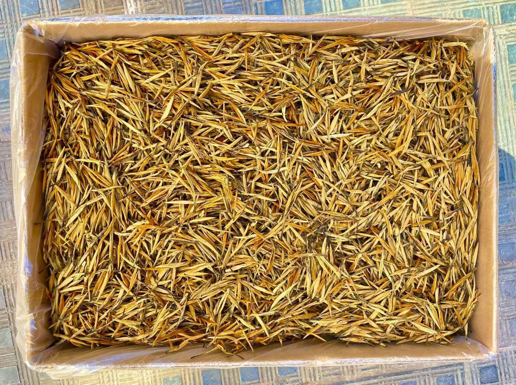 Golden Needle Black Tea 2026 New Harvest Box filled with yellow dried leaves on a patterned surface