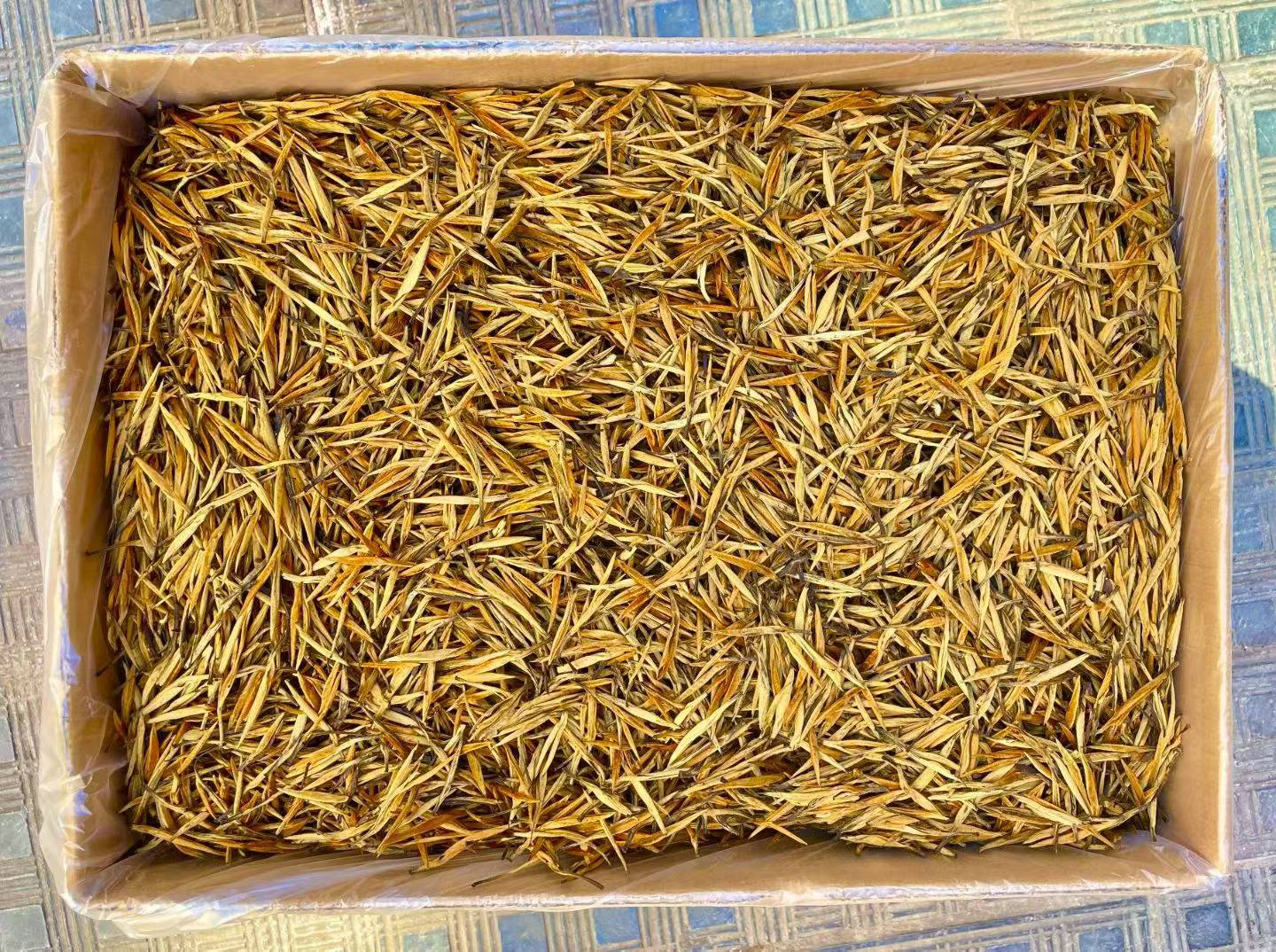 Golden Needle Black Tea 2026 New Harvest Box filled with yellow dried leaves on a patterned surface