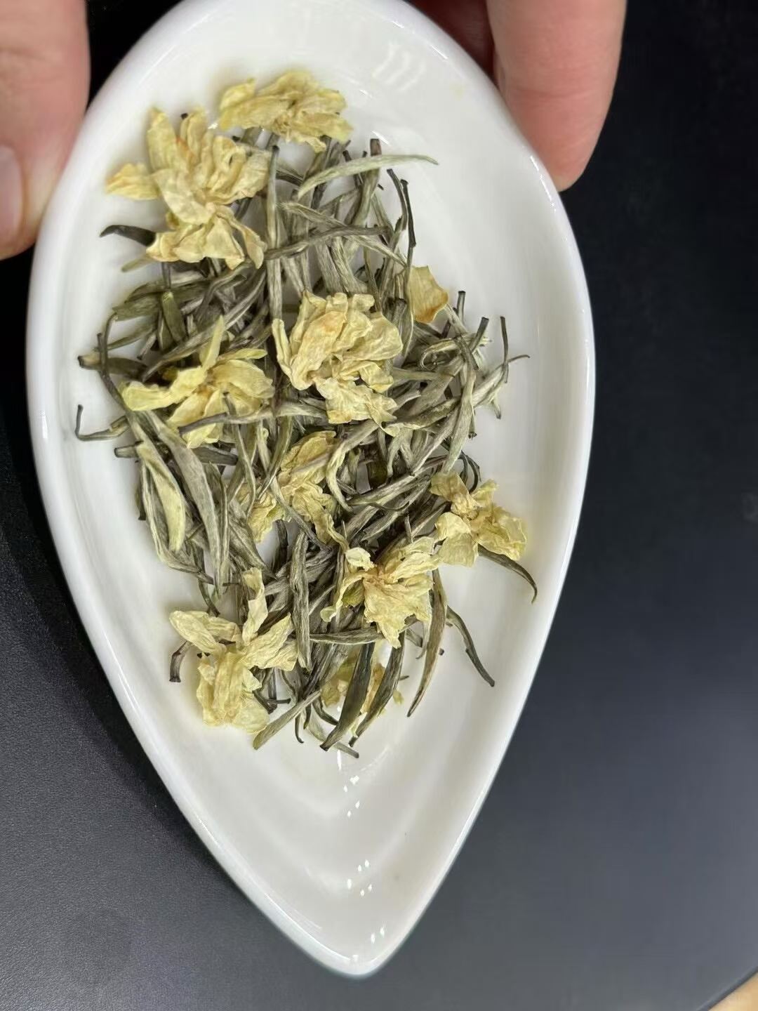 jasmine Needle King -- silver needle tea scented multiple rounds with fresh jasmine. Rock sugar sweet, 10+ steeps, fragrance that holds. 2026 spring harvest.