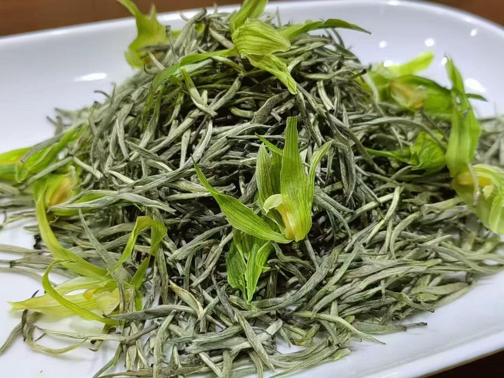 Orchid Blossom Tea · 2026 First Spring | Fresh-Scented Green Tea with Wild Orchid Green tea leaves on a white plate