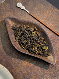 Stem-on Tieguanyin, traditional Anxi old-style oolong. Orchid fragrance, roasted warmth, naturally sweet. A taste of how Tieguanyin was made before everything changed.