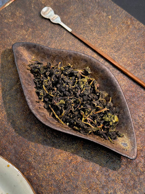Stem-on Tieguanyin, traditional Anxi old-style oolong. Orchid fragrance, roasted warmth, naturally sweet. A taste of how Tieguanyin was made before everything changed.