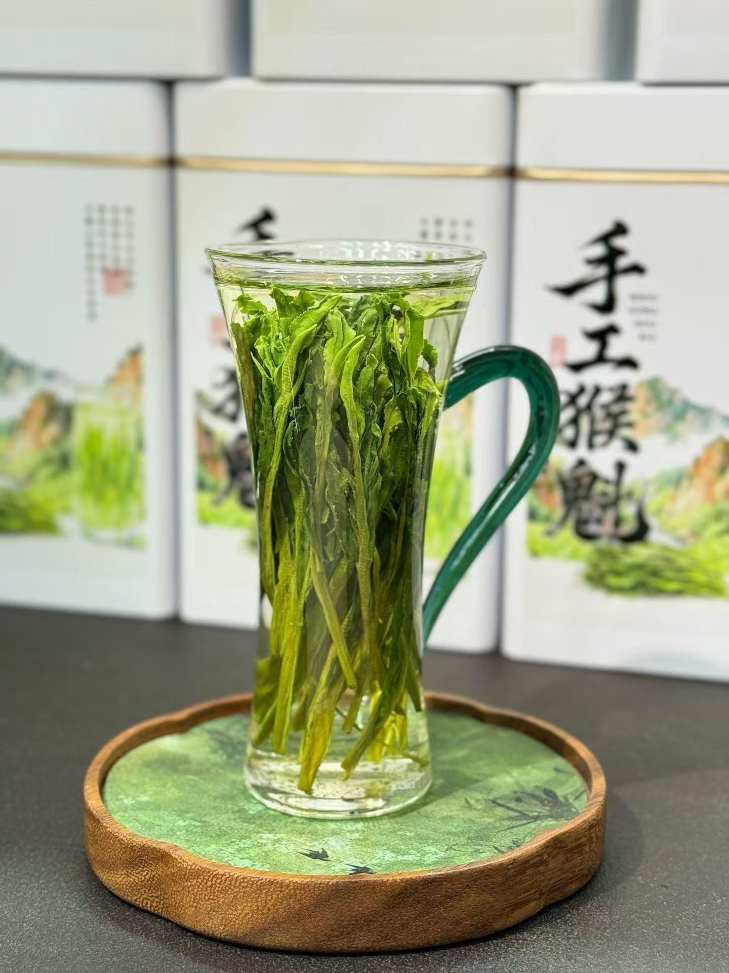 Taiping Houkui hand-pressed green tea from Huangshan's high mountains. First-flush leaves, intangible-heritage craft, sword-straight blades, clear emerald liquor. Orchid-soft and sweet.